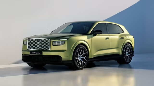 The 2028 Bentley Torcal electric SUV in lime green, front three-quarter studio view showing the diamond-pattern grille and TORCAL front badge
